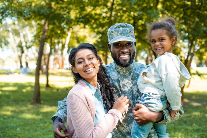 Happy military foster family, mom, dad, and daughter
