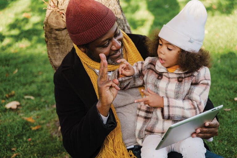 vecteezy_black-grandfather-and-granddaughter-using-tablet-computer_4225654