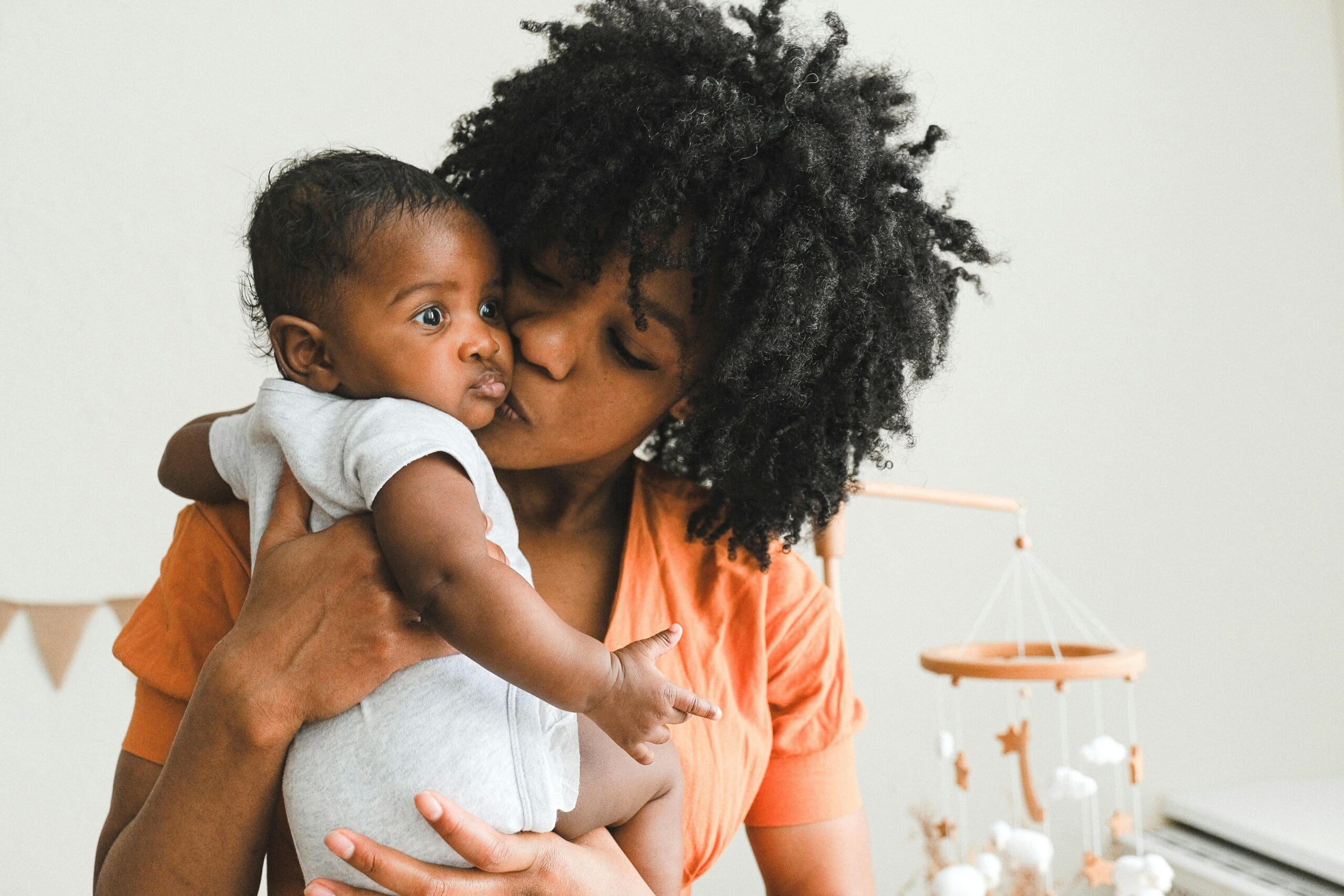 african american woman kissing baby