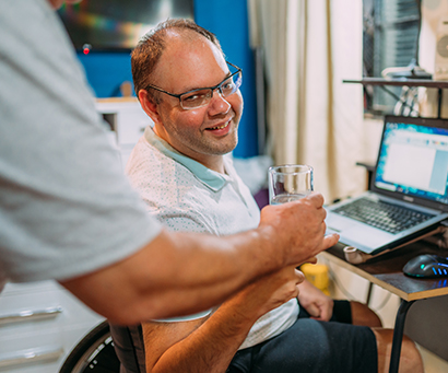 man in wheelchair receiving water