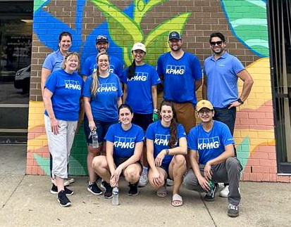 group photo of people in blue shirts