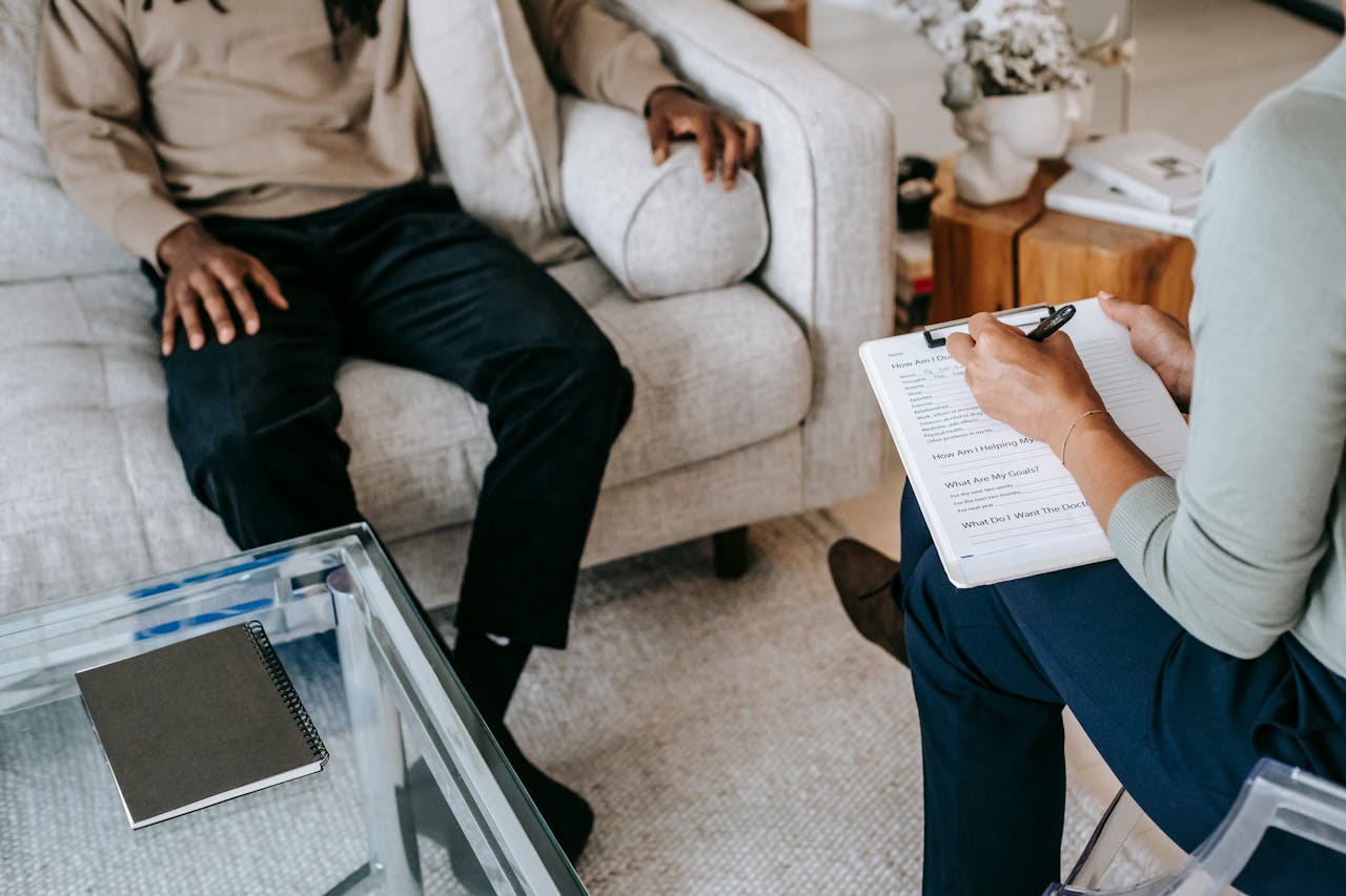 two people sitting in a therapy office talking, benefits of becoming a foster parent