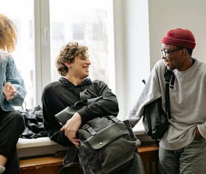 teens talking in front of a window
