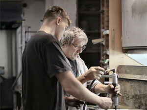 young white male learning trade from older white male