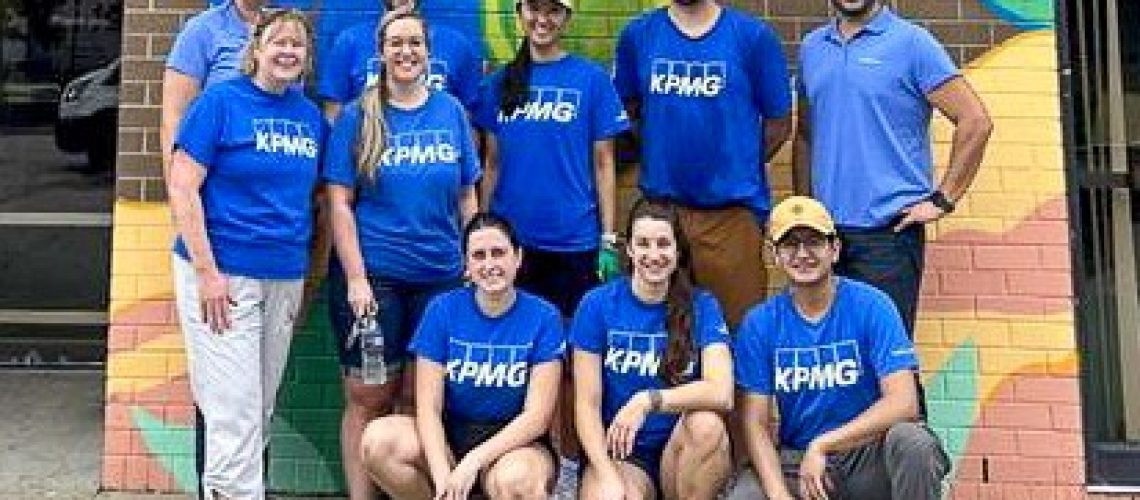 group photo of people in blue shirts