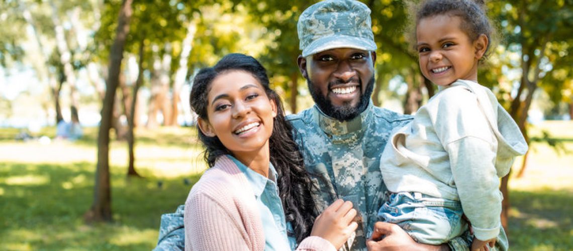Happy military foster family, mom, dad, and daughter