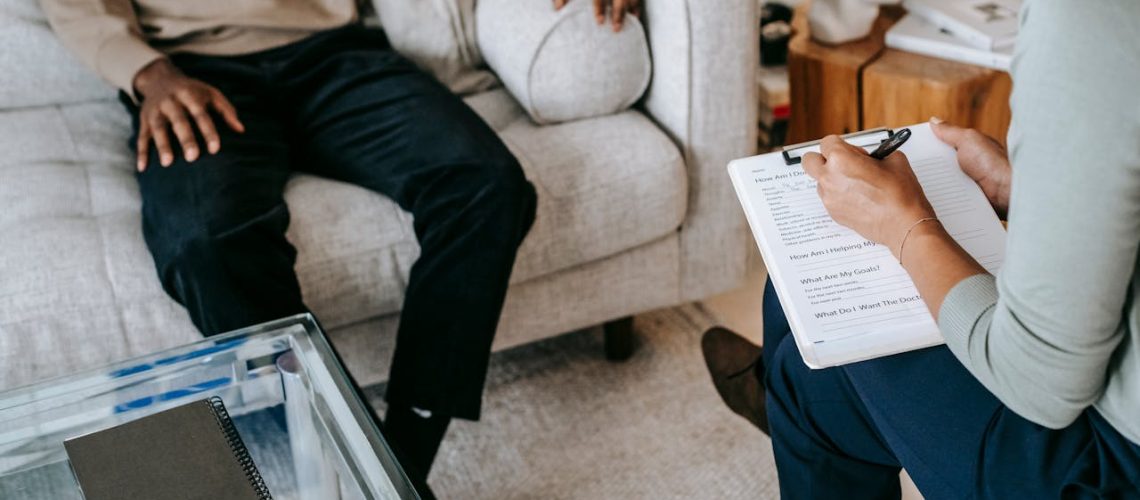 two people sitting in a therapy office talking, benefits of becoming a foster parent
